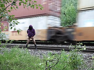 Shy transgender flashing by train tracks 