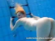 Cute Lucie is stripping underwater