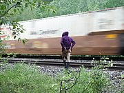 Shy transgender flashing by train tracks 