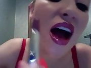Sexy woman putting on lipstick