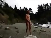 stroking on nude beach, stranger finishes him off