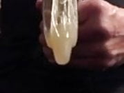 Jerking with a friends used condom on my cock