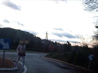 schoolgirl flashing on traffic circle roadsigns plugged