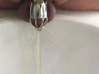 Pissing in my chastity cage