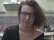 Solo girl with glasses chatting in the kitchen 