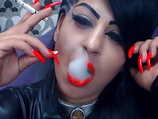 Smoking with red lips and long nails