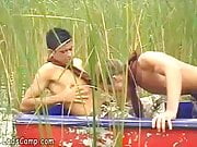Hot boys rowing in a boat and sucking