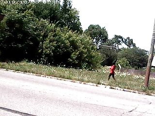 Detroit skinny black Street hooker in red tight mini dress.