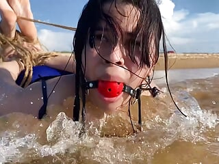 Ball Gagged Latina Hogtied In The Sea