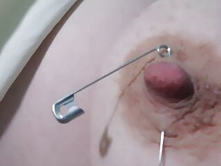 Master piercing my nipple with a safety pin